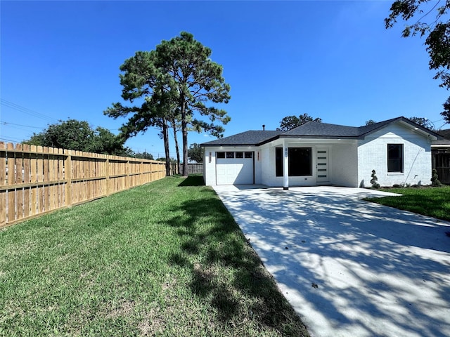 view of front of house with a front yard and a garage