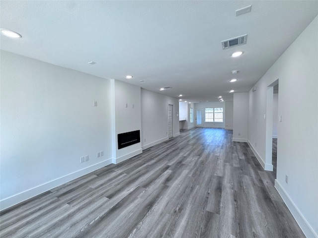 unfurnished living room featuring dark hardwood / wood-style flooring