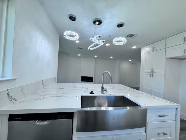 kitchen with white cabinets, light stone counters, sink, decorative light fixtures, and dishwasher