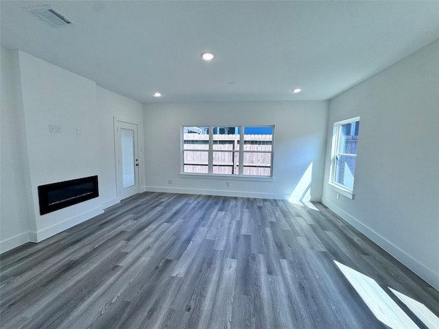 unfurnished living room with dark hardwood / wood-style flooring