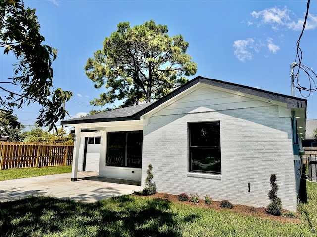 rear view of house featuring a yard and a garage