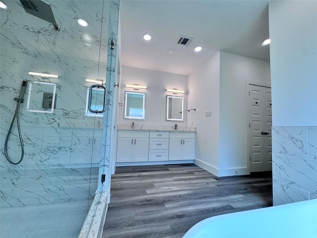 bathroom with vanity, hardwood / wood-style flooring, and a shower with door