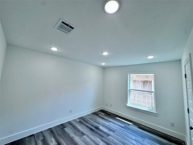 spare room with hardwood / wood-style floors