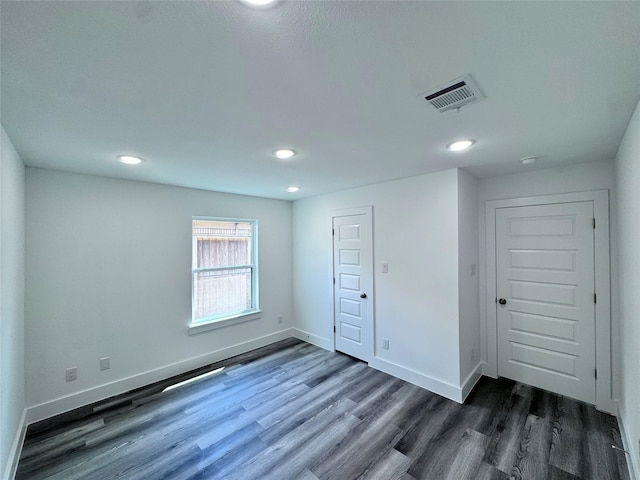 unfurnished bedroom featuring dark hardwood / wood-style flooring