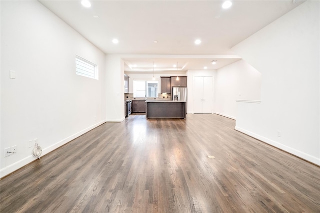 unfurnished living room with dark hardwood / wood-style flooring