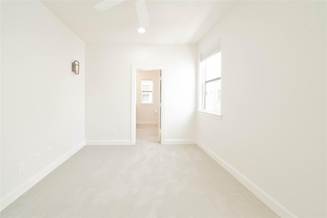 carpeted spare room with ceiling fan