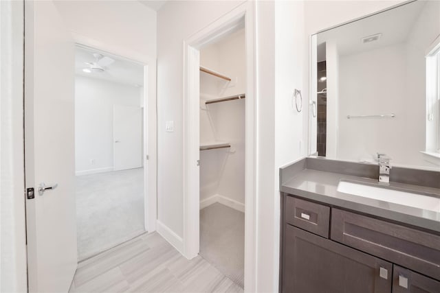 bathroom with ceiling fan and vanity