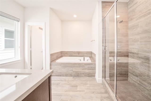 bathroom with separate shower and tub