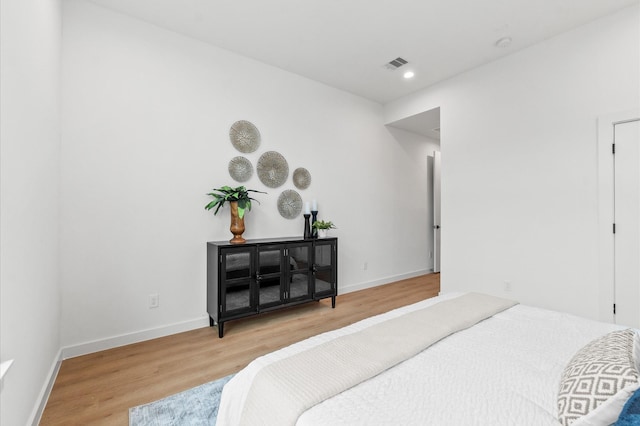 bedroom with hardwood / wood-style flooring