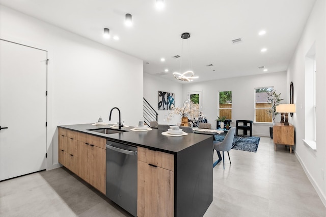 kitchen featuring hanging light fixtures, light brown cabinetry, sink, and stainless steel dishwasher