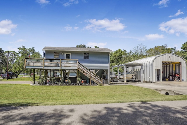 back of property with a lawn, a carport, and a wooden deck