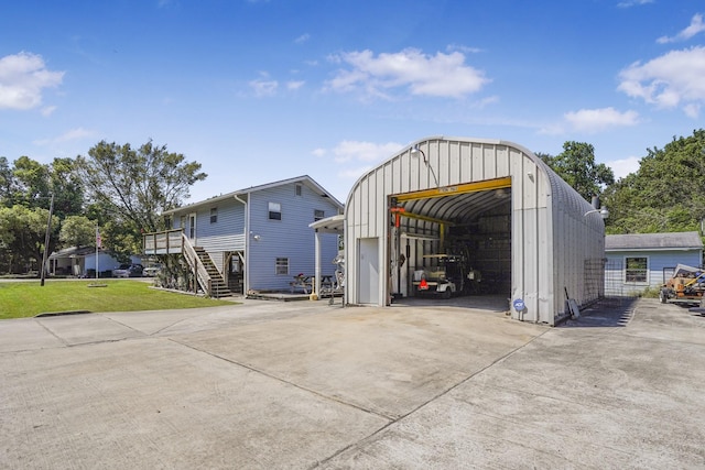 view of outdoor structure featuring a lawn and a garage