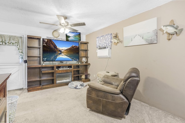 living room with carpet flooring, ceiling fan, and a textured ceiling