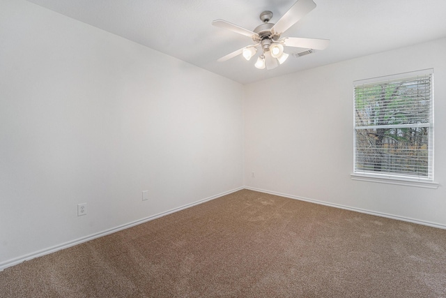 carpeted empty room featuring ceiling fan