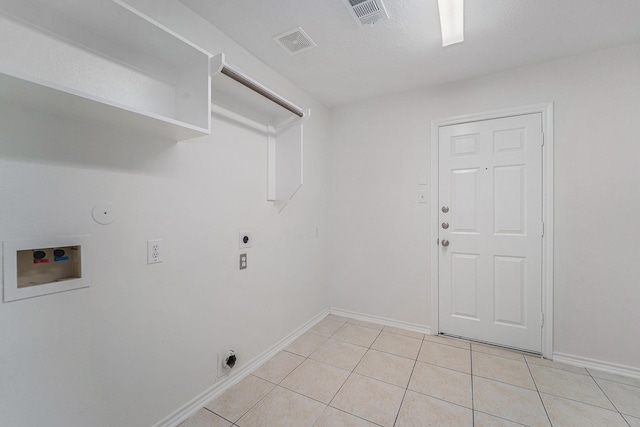 washroom with gas dryer hookup, washer hookup, light tile patterned floors, and hookup for an electric dryer