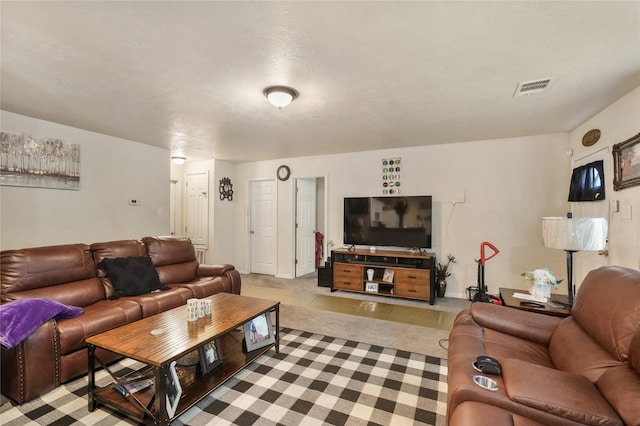 carpeted living room featuring a textured ceiling