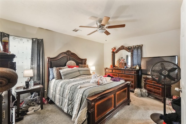 bedroom with light carpet and ceiling fan