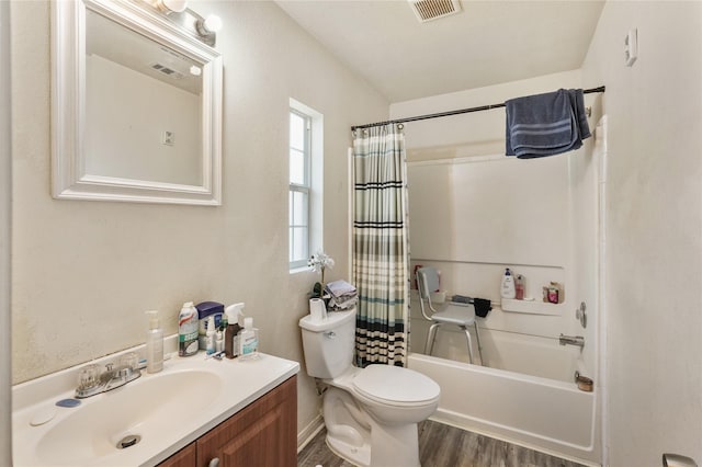 full bathroom featuring vanity, wood-type flooring, shower / tub combo, and toilet