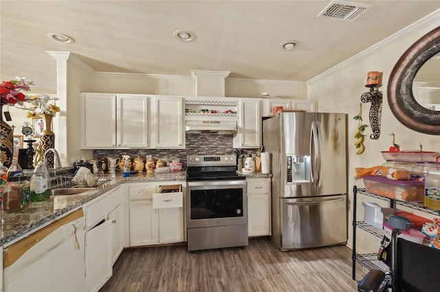 kitchen with white cabinets, premium range hood, stainless steel appliances, and hardwood / wood-style flooring