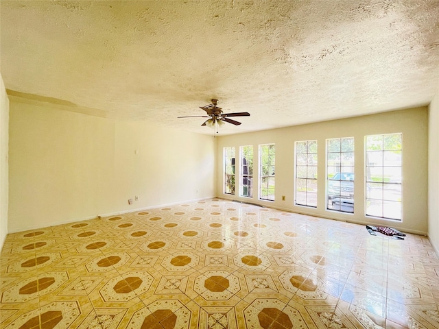 spare room with ceiling fan and a textured ceiling