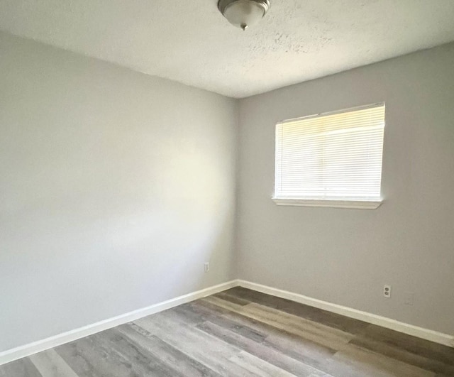 empty room with wood-type flooring