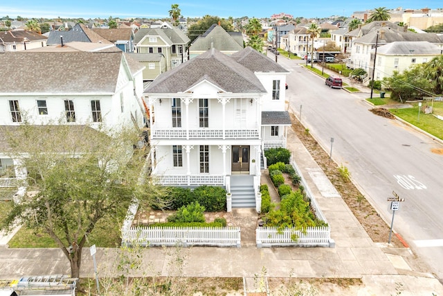 view of front of house with covered porch and a balcony