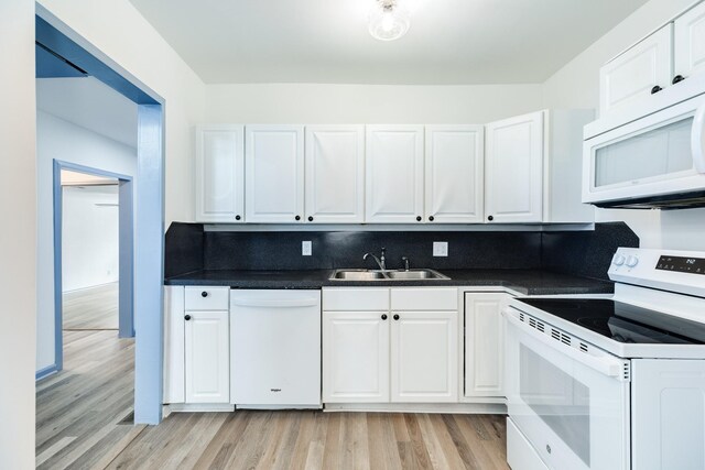 kitchen with light hardwood / wood-style floors, white cabinetry, white appliances, and sink