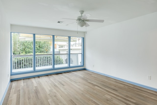 unfurnished room featuring light hardwood / wood-style flooring, plenty of natural light, and ceiling fan