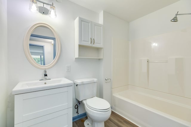 full bathroom with shower / bathing tub combination, hardwood / wood-style floors, vanity, and toilet