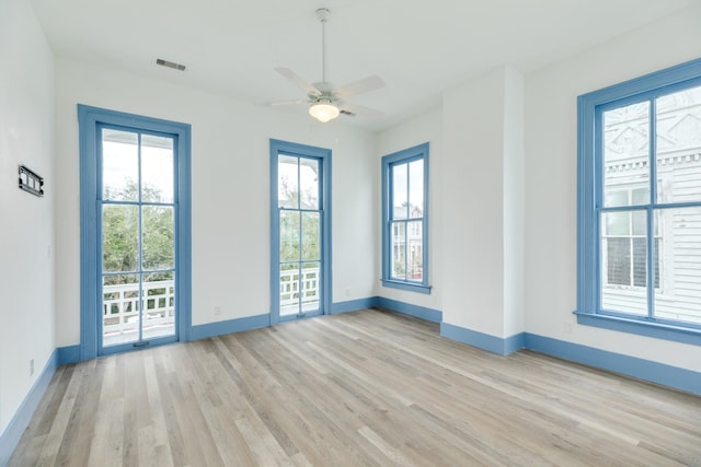 unfurnished room with ceiling fan and light wood-type flooring