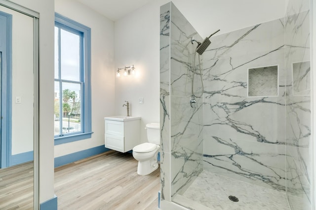 bathroom with hardwood / wood-style floors, vanity, toilet, and an enclosed shower