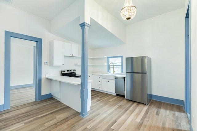 kitchen featuring appliances with stainless steel finishes, light hardwood / wood-style floors, white cabinetry, and sink