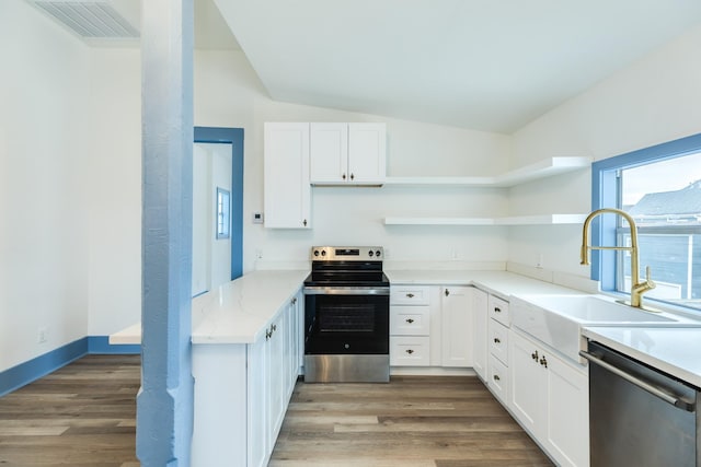 kitchen with wood-type flooring, sink, white cabinetry, and stainless steel appliances