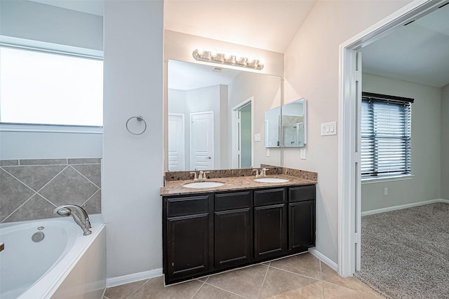 bathroom with tile patterned flooring, vanity, and a tub to relax in