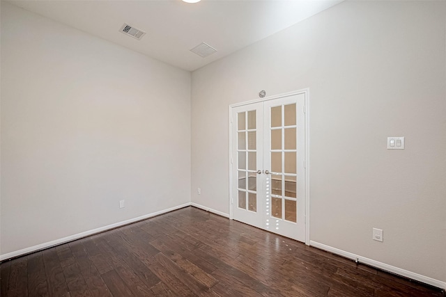 empty room featuring french doors and dark hardwood / wood-style floors