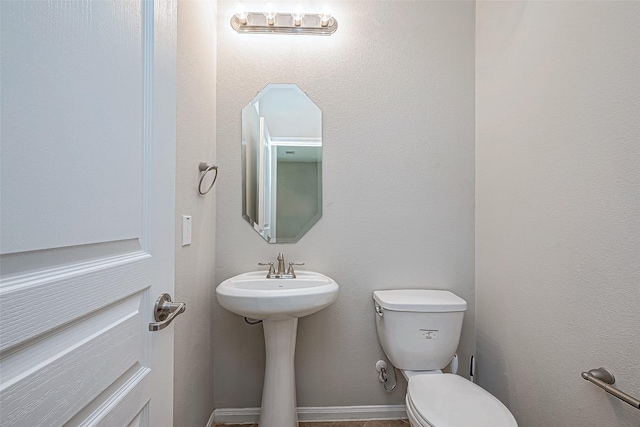 bathroom featuring toilet and sink