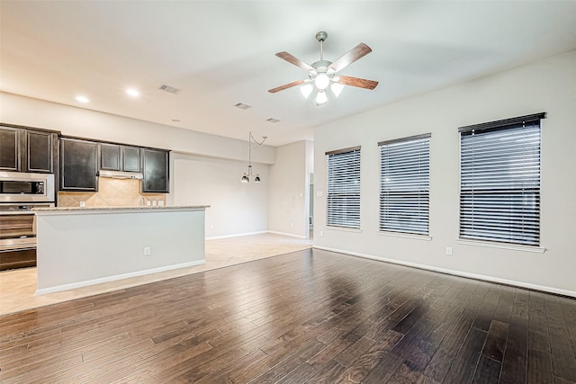 unfurnished living room with ceiling fan and light hardwood / wood-style floors