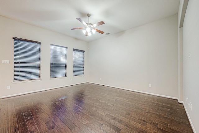 empty room featuring ceiling fan and dark wood-type flooring