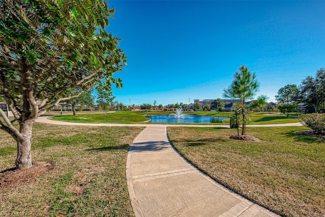 view of home's community with a yard and a water view