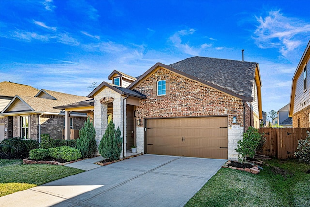 view of front of property featuring a garage and a front lawn