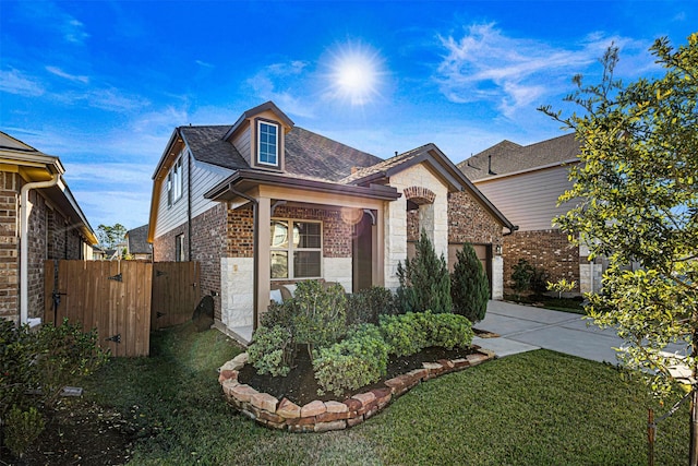 view of front of property with a front yard and a garage