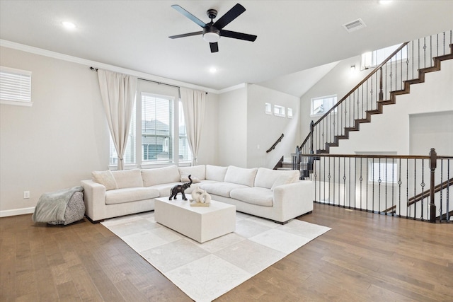 living room with hardwood / wood-style flooring, ceiling fan, and ornamental molding