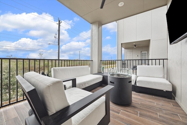 wooden terrace featuring an outdoor living space and ceiling fan