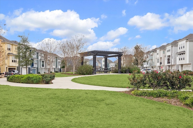 surrounding community featuring a yard and a pergola