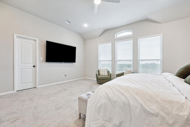 bedroom with ceiling fan, vaulted ceiling, and light carpet