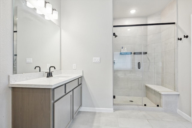 bathroom featuring tile patterned floors, vanity, and a shower with door