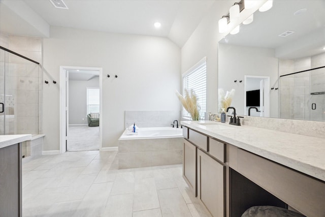 bathroom featuring tile patterned flooring, vanity, and separate shower and tub