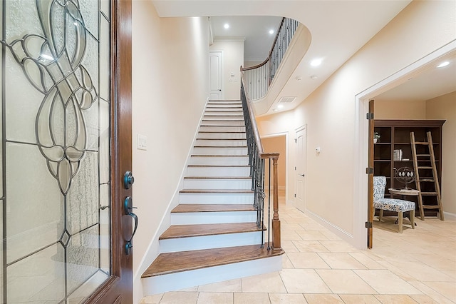 stairway featuring tile patterned flooring