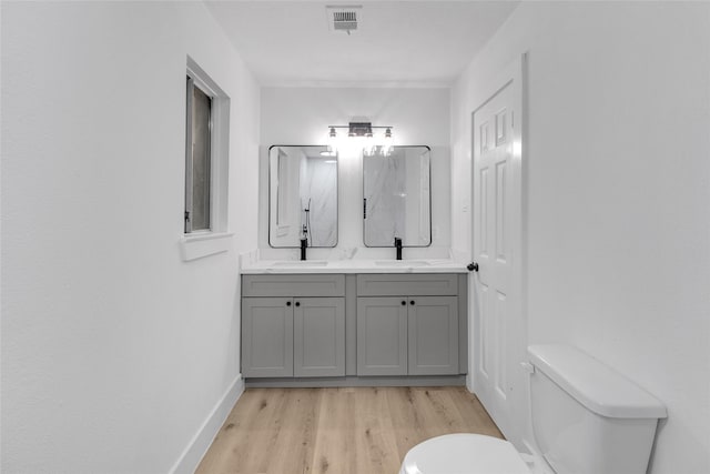 bathroom featuring hardwood / wood-style floors, vanity, and toilet