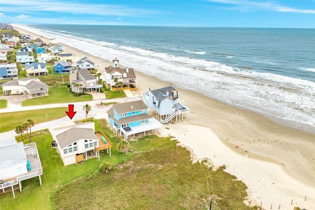 aerial view featuring a water view and a beach view